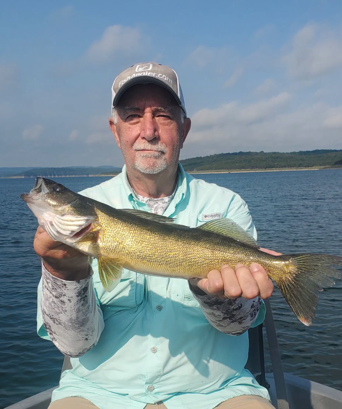 Angler holding a largemouth bass caught on Bull Shoals Lake